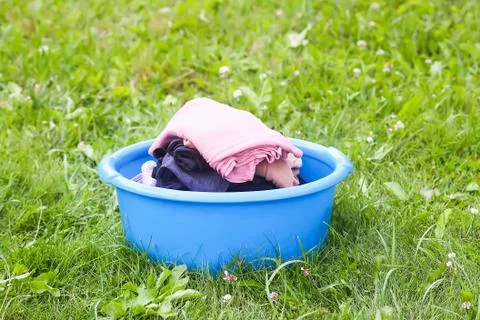 Stack of clean laundry in the large plastic cup outdoors Stock Photos
