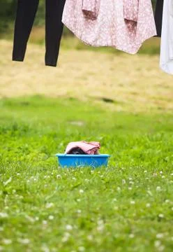 Stack of clean laundry in the large plastic cup outdoors Stock Photos