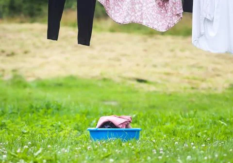 Stack of clean laundry in the large plastic cup outdoors Stock Photos