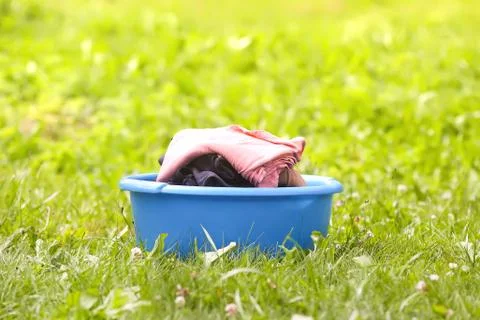 Stack of clean laundry in the large plastic cup outdoors Stock Photos