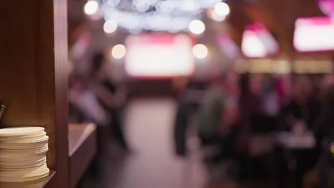 Stack of clean plates in foreground with blurred restaurant event hall and Stock Footage 346734573