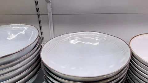 Stack of clean plates on a shelf in the kitchen, close-up Stock Footage 256047628