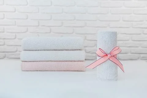 Stack of clean soft towels on brick wall background Stock Photos