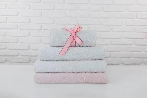 Stack of clean soft towels on brick wall background Stock-Fotos
