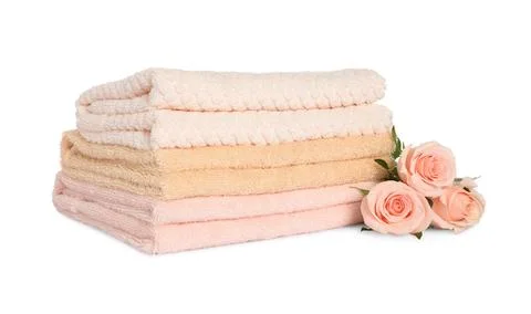 Stack of clean soft towels with flowers isolated on white Stock Photos