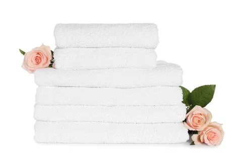 Stack of clean soft towels with flowers isolated on white Stockfoto's