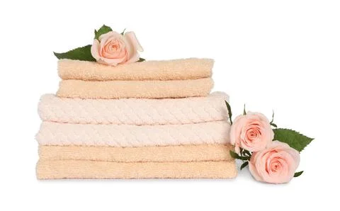 Stack of clean soft towels with flowers isolated on white Stock Photos