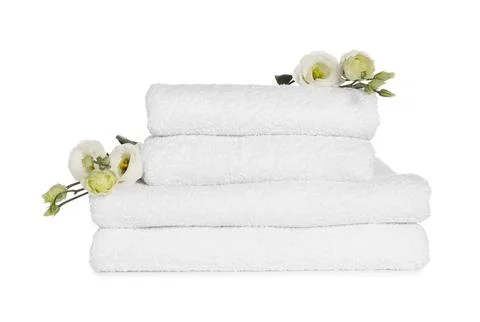 Stack of clean soft towels with flowers isolated on white 스톡 사진