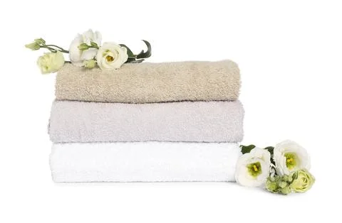 Stack of clean soft towels with flowers isolated on white Foto stock