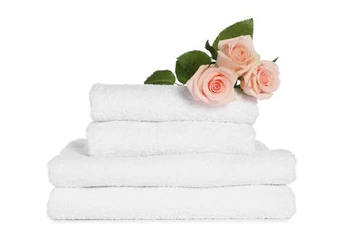 Stack of clean soft towels with flowers isolated on white Stockfoto's