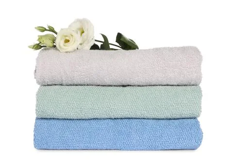 Stack of clean soft towels with flowers isolated on white 스톡 사진