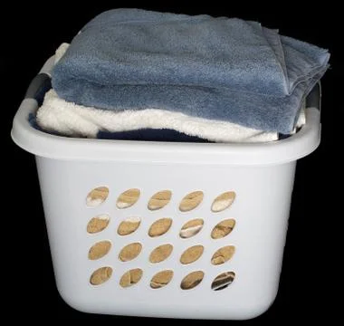 Stack of clean towels in basket Stock Photos