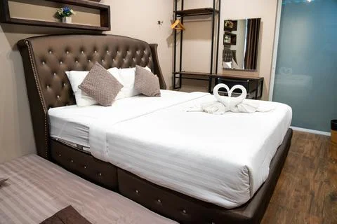 Stack of clean towels on bed in bedroom. 스톡 사진