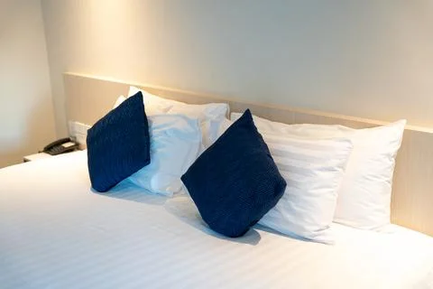 Stack of clean towels on bed in bedroom. Stock Photos