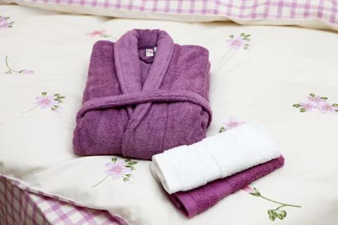 Stack of clean towels on bed Stock Photos