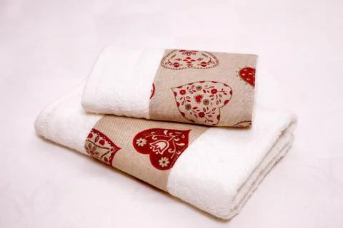 Stack of clean towels on bed Stock Photos