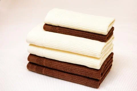 Stack of clean towels on bed Stock Photos