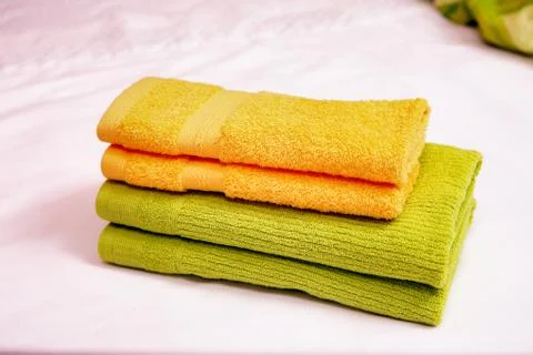 Stack of clean towels on bed Stock Photos