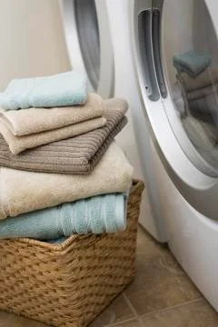 Stack of Clean Towels Beside Washer and Dryer Foto stock
