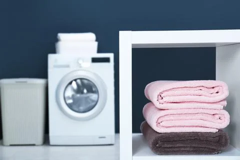 Stack of clean towels on shelf in laundry room. Space for text 스톡 사진