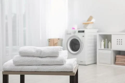 Stack of clean towels on table in bathroom.  Space for text 스톡 사진