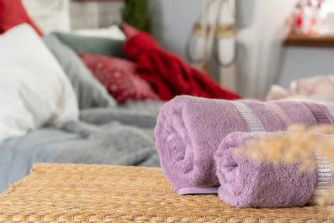 Stack of clean towels on wooden table in bedroom Stock Photos