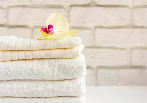 A stack of clean white Terry towels on a light background Stock Photos