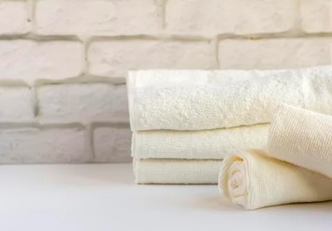 A stack of clean white Terry towels on a light background Stock Photos