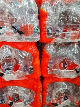 Stack of Cleo drinking water bottles at the supermarket. Stock Photos