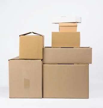 Stack of closed cardboard brown paper boxes on white background, moving conce Stock Photos