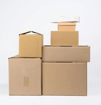 Stack of closed cardboard brown paper boxes on white background, moving co... Stockfoto's