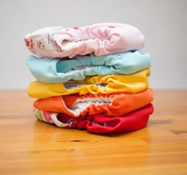Stack of cloth diapers on a wooden table Stock Photos