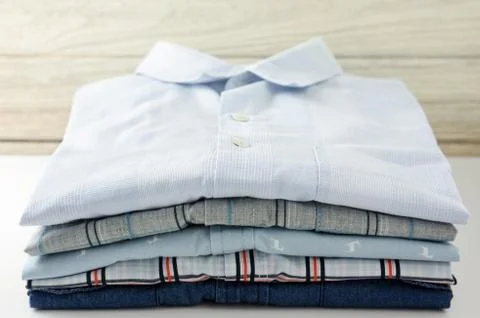 Stack of clothes closeup with white wood background Stock Photos