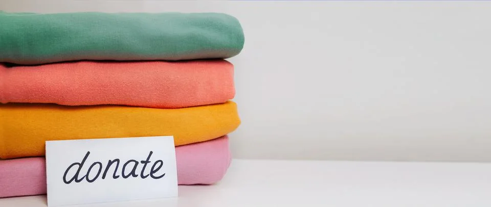 A stack of clothes. Clothes Donation, Renewable Concept. Preparing Garment at Stock Photos