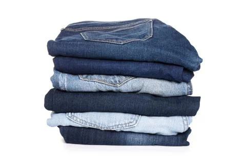 A stack of clothes jeans pants on a white background. Isolation Stock Photos
