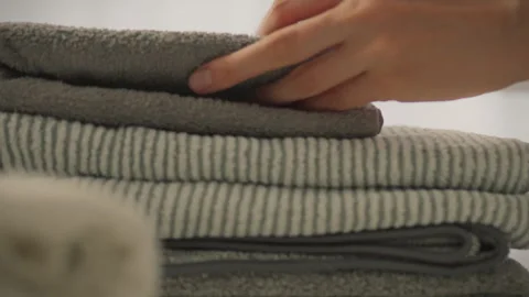 Stack of clothes neatly folded by modern housewife after washing and drying. Stock Footage 273701179