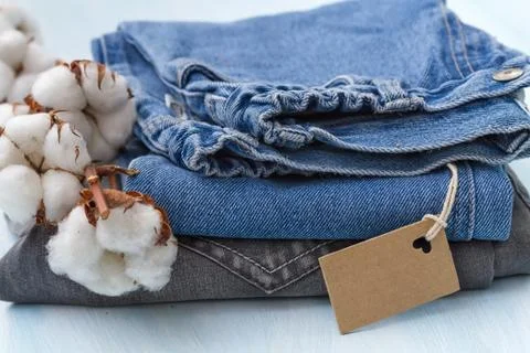 Stack of clothes with a sprig of cotton Stock Photos