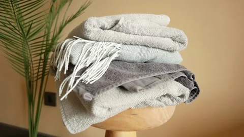 Stack of clothes on table indoor. Stock Footage 259365571