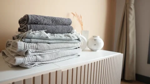 Stack of clothes on table indoor. Stock Footage 262213847