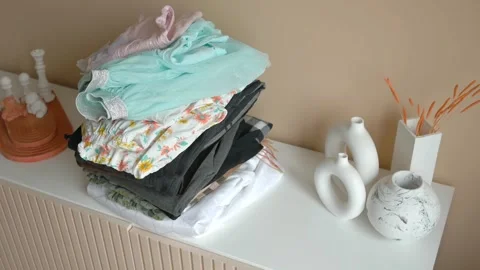 Stack of clothes on table indoor. Stock Footage 263731447