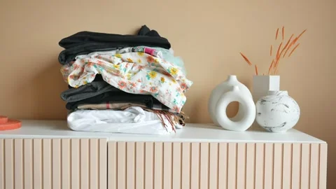 Stack of clothes on table indoor. Stock Footage 274776326