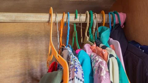 Stack of clothes in wardrobe. stack of colorful folded clothing items. Stock Photos