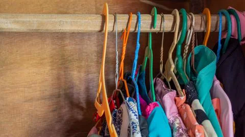 Stack of clothes in wardrobe. stack of colorful folded clothing items. Stock Photos