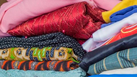 Stack of clothes in wardrobe. stack of colorful folded clothing items. Stock Photos