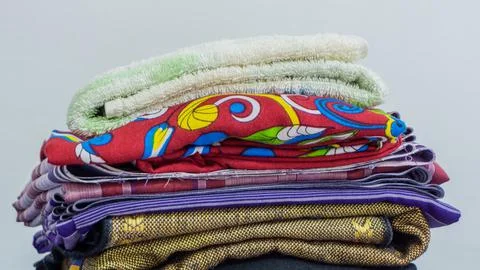 Stack of clothes in wardrobe. stack of colorful folded clothing items. Stock Photos