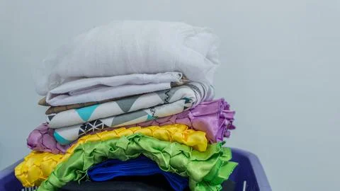 Stack of clothes in wardrobe. stack of colorful folded clothing items. Stock Photos