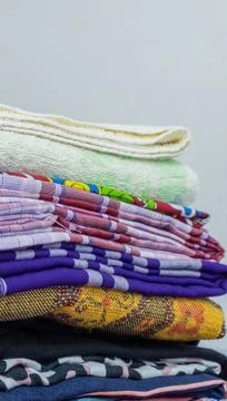 Stack of clothes in wardrobe. stack of colorful folded clothing items. Stock Photos