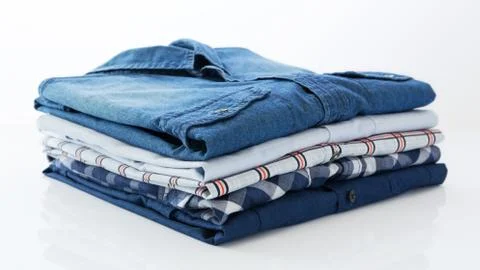 Stack of clothes on white background Stock Photos