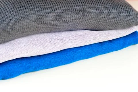 Stack of clothing isolated on white, sweaters, Shirts, knitwear Stock Photos