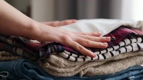 Stack clothing for sorting and baggage packing. Clothes for donation Stock Footage 146793831